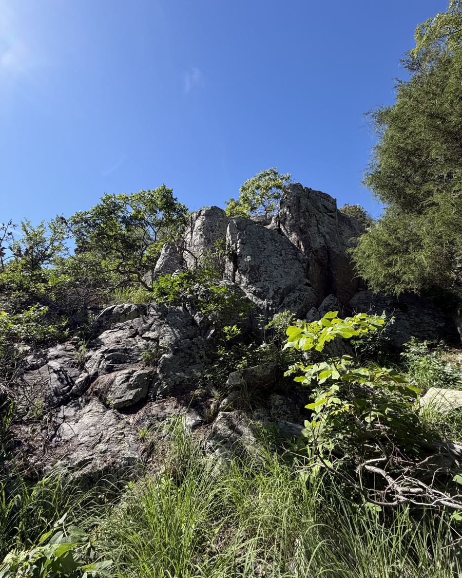 Granite outcrops rising against a clear blue sky